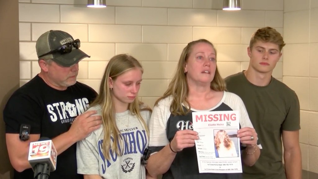Family of missing Eliotte Heinz holding a missing person poster.