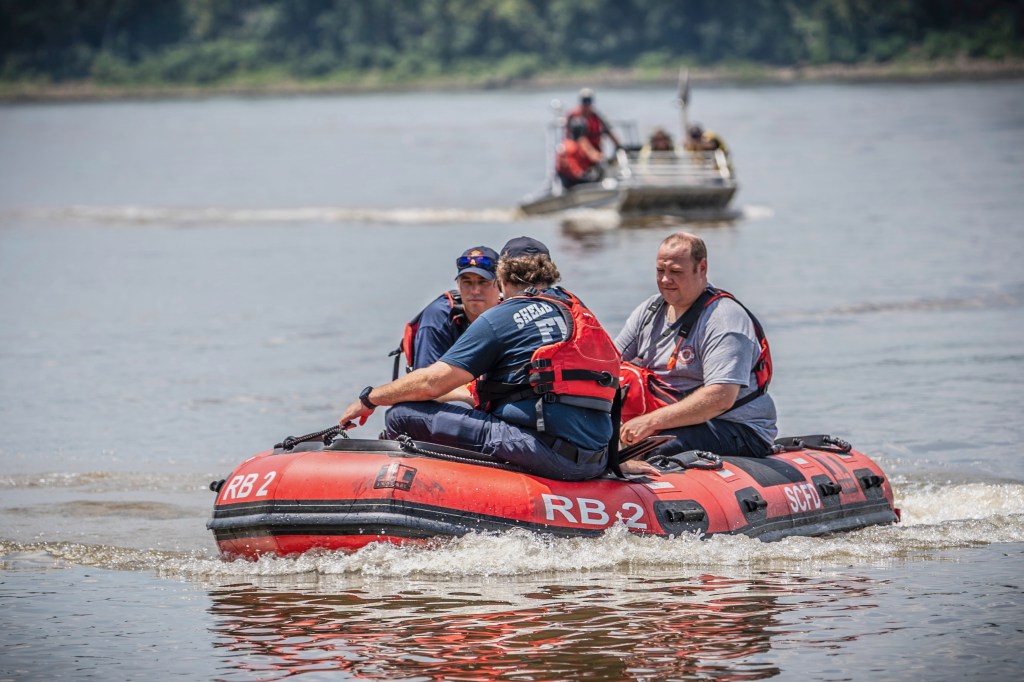 Search and rescue team in a boat on the Mississippi River.