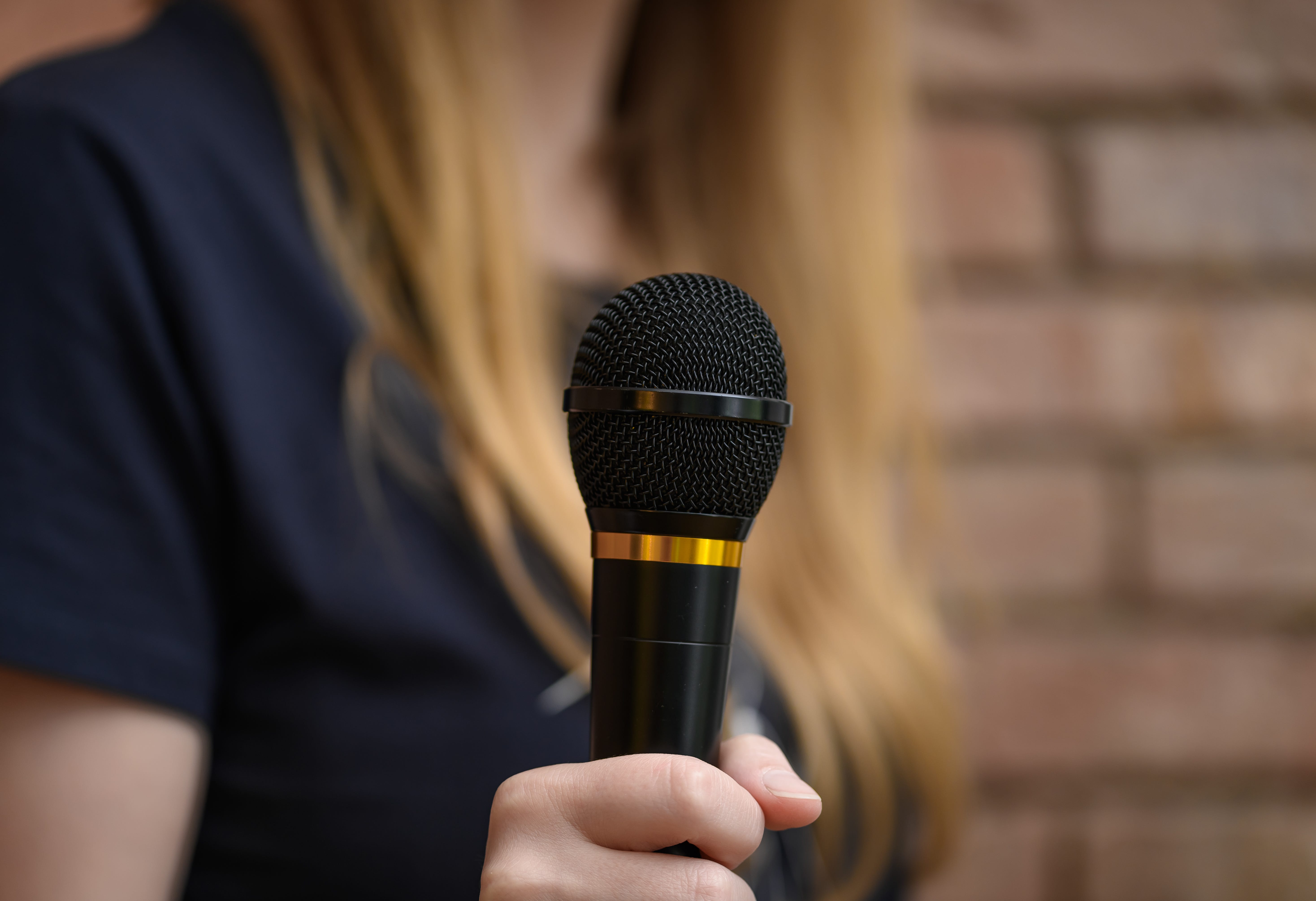 a person holding a mic on stage