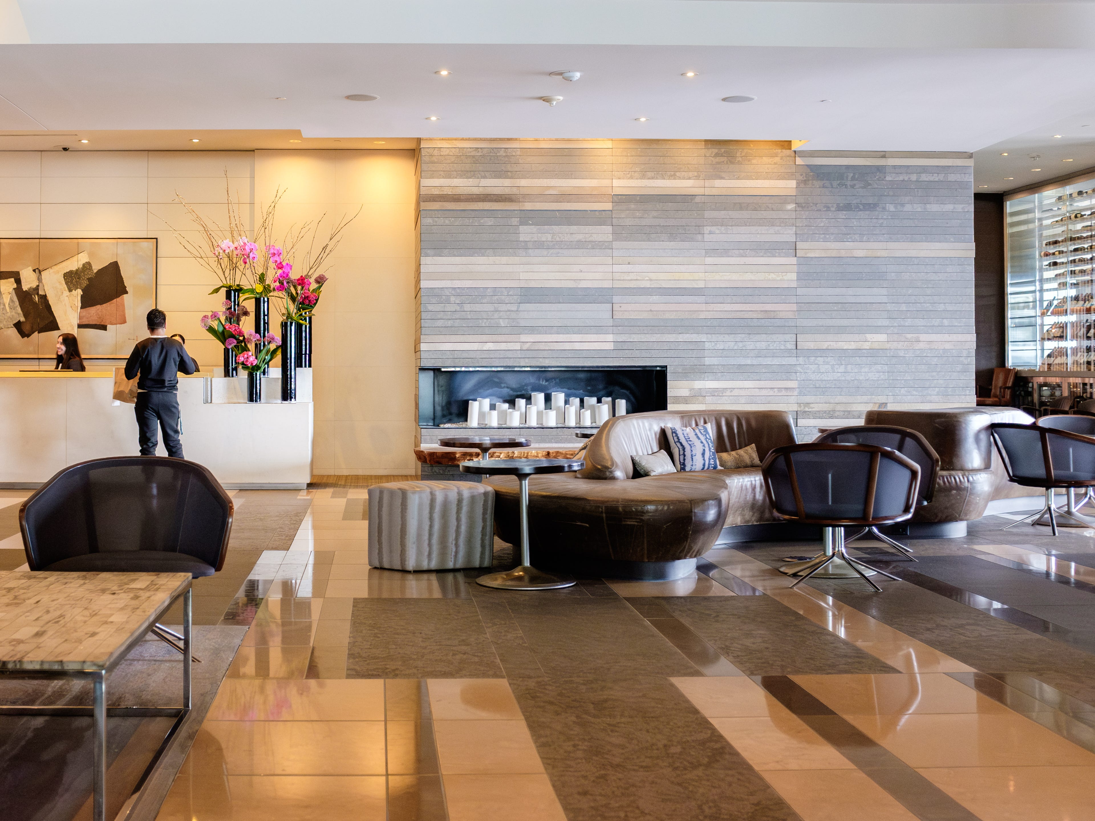 Inside the lobby at the Four Seasons Seattle with seating on the right and a check-in counter on the left