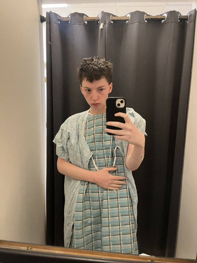 Miles Yardley in hospital gown taking a selfie.