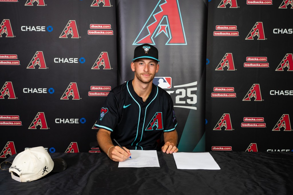 Joe Ariola signing his Arizona Diamondbacks contract.