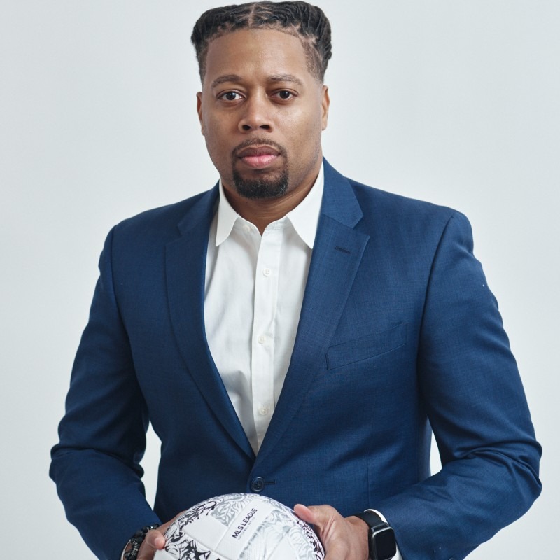 Portrait of Cedric D. Shine holding a soccer ball.