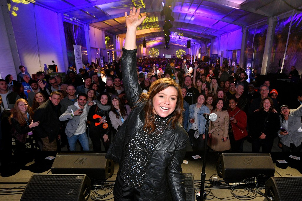 Rachael Ray on stage with a crowd of people.