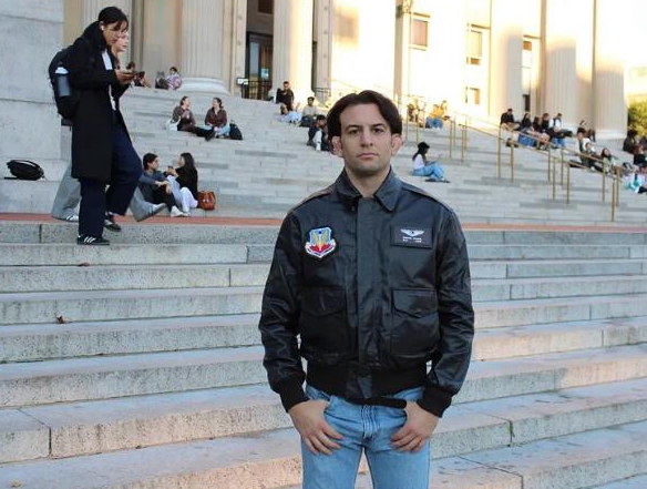 Sam Nahins, a Columbia University graduate student and veteran US Air Force drone pilot, on the steps of a building.