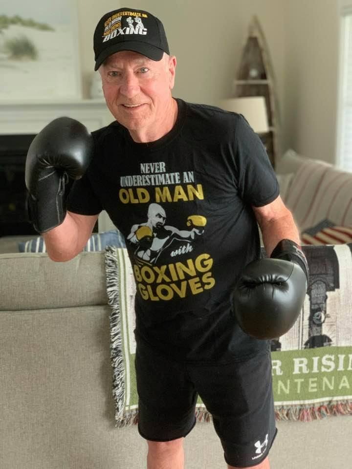 megahey in black shirt and shorts and cap and boxing gloves