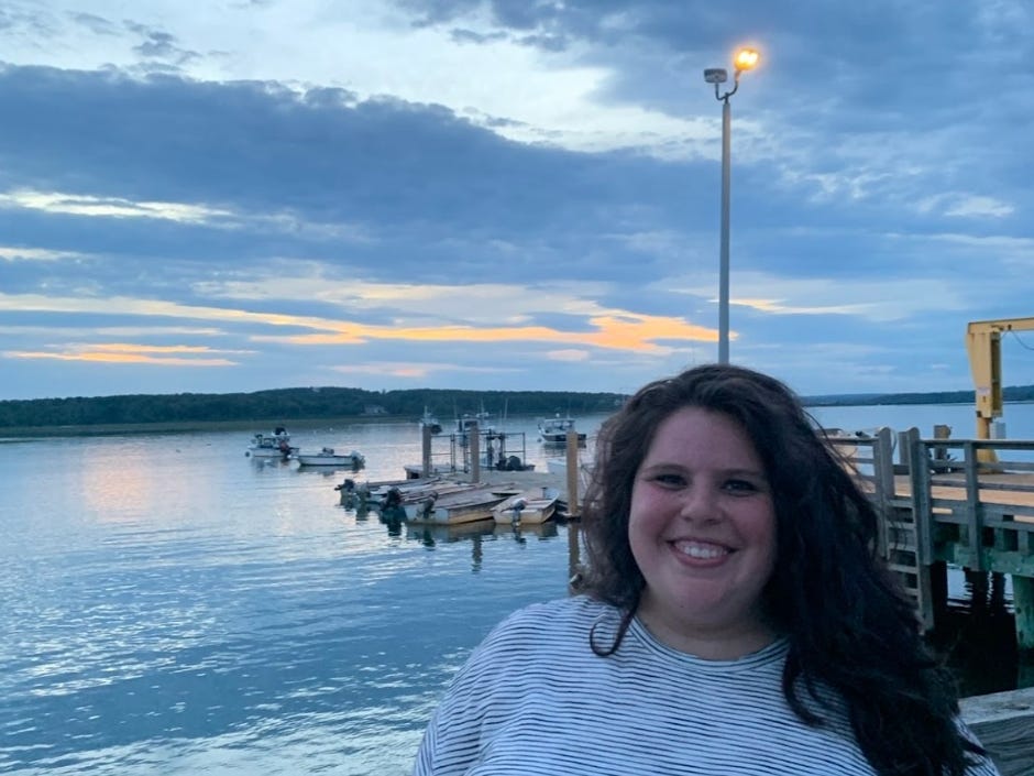 The writer in Maine, in front of the water.