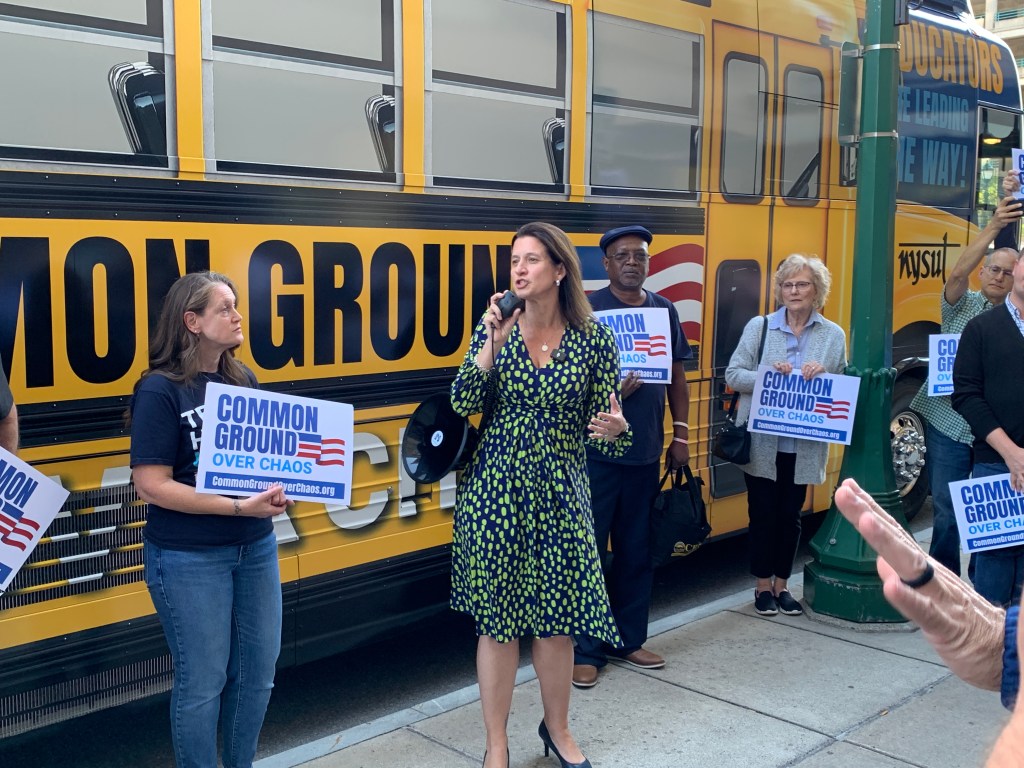 NYSUT President Melinda Person speaking at a Common Ground Over Chaos bus tour.