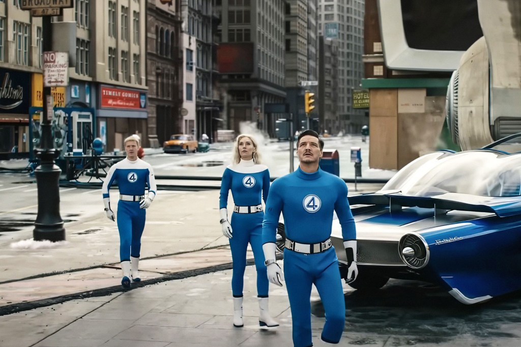 The Fantastic Four in their blue suits walking down a city street next to their car.