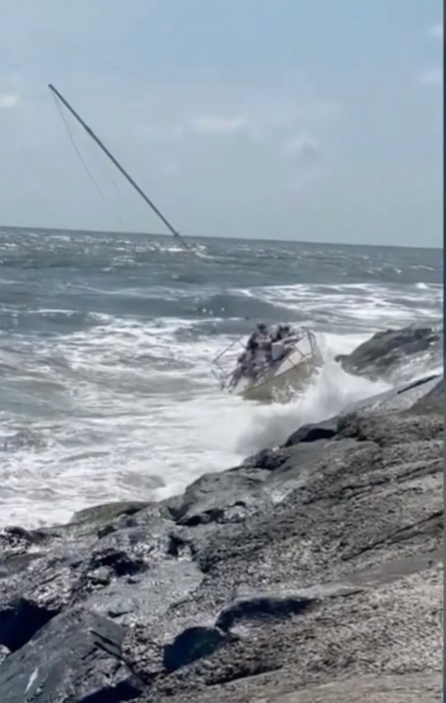 Sailboat crashing into New Jersey jetty in rough waters.