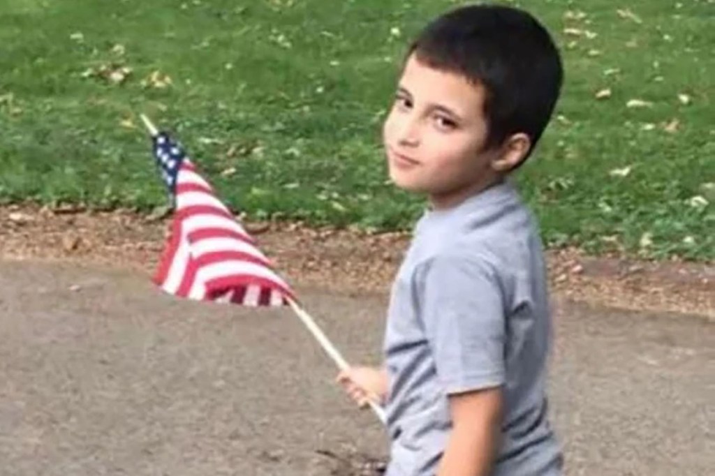 Photo of Wadea Al-Fayoume holding an American flag.