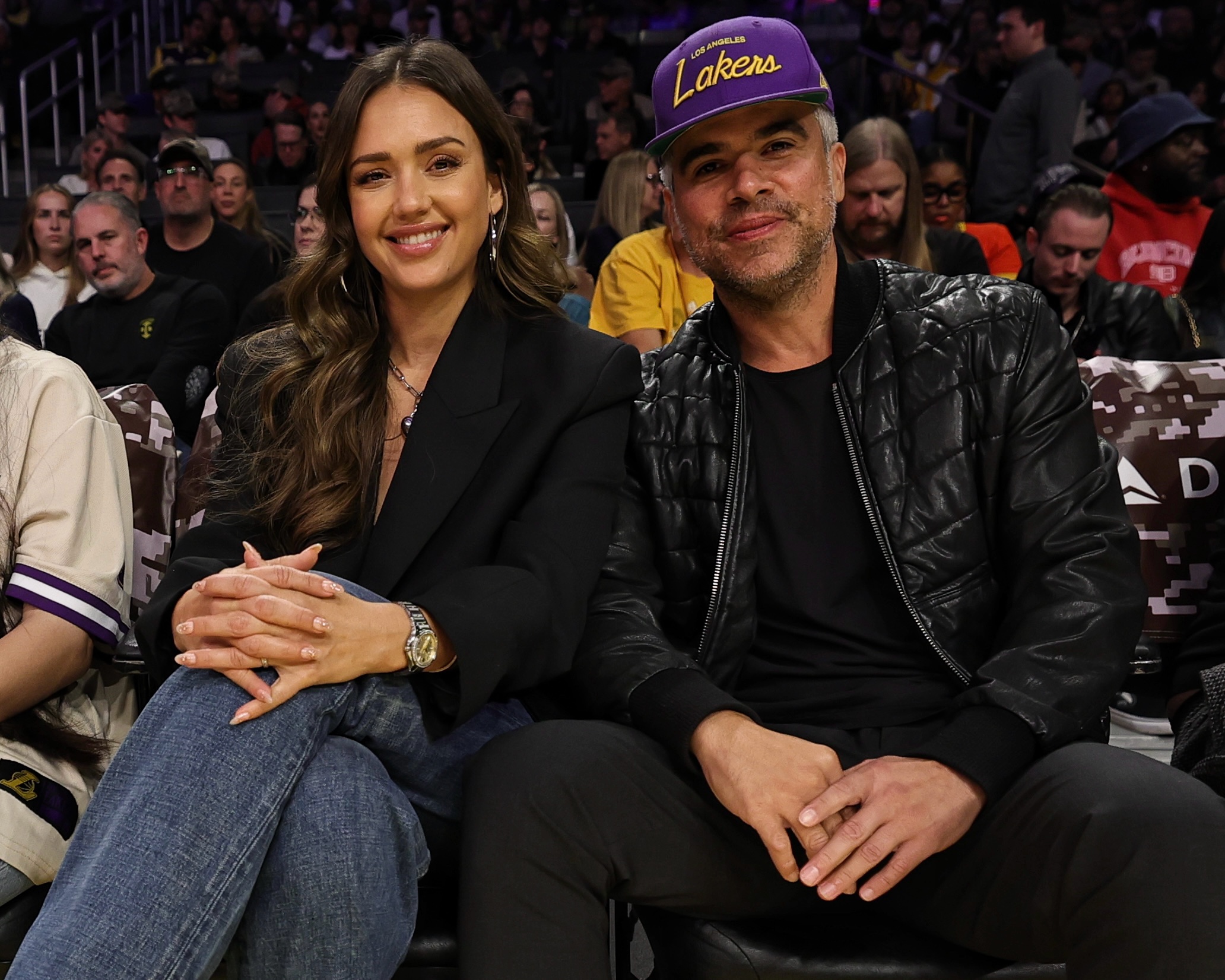 Jessica Alba and Cash Warren sit courtside. 