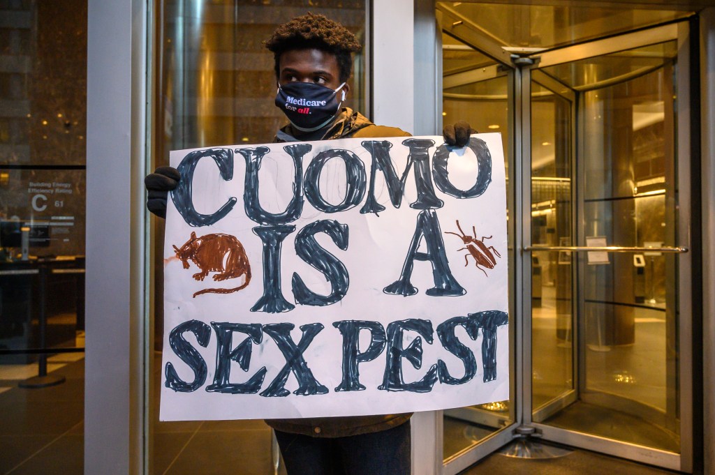 A demonstrator holds a sign during a rally calling for Gov. Andrew Cuomo's resignation in front of the governor's Manhattan office on March 2, 2021.