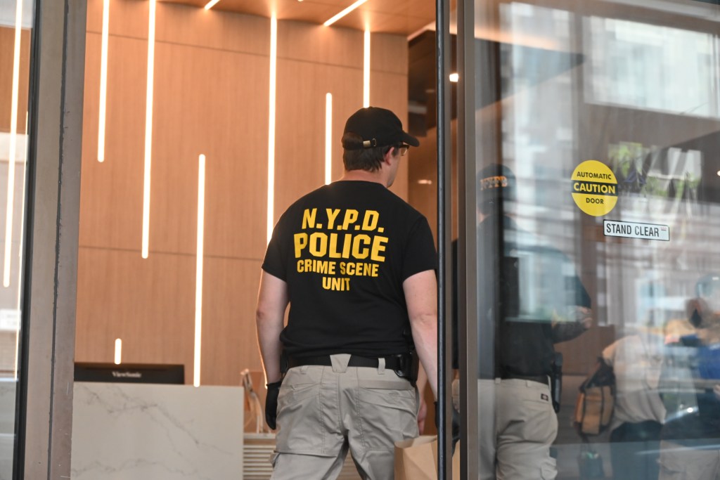 NYPD crime scene unit officer at an apartment building.