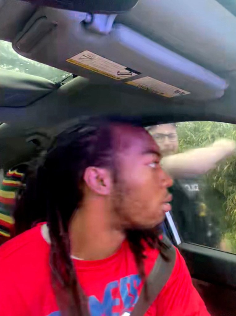 William McNeil Jr. sits in his car as a Jacksonville Police officer attempts to punch open the window during a traffic stop on Feb. 19, 2025.