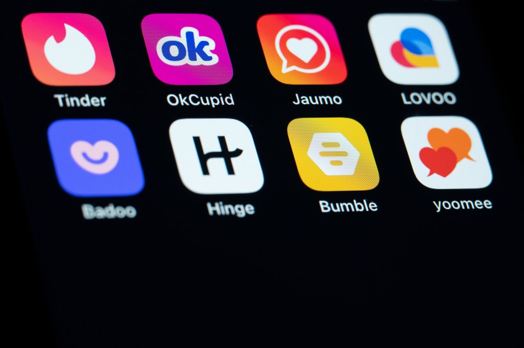 Smartphone screen displaying various dating app icons.