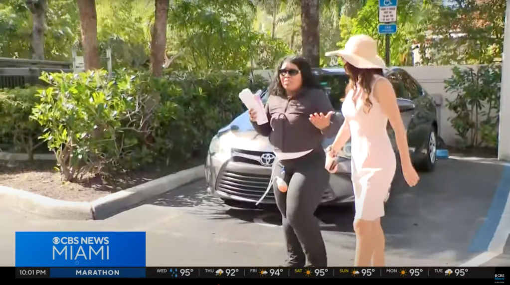 Screenshot of two women arguing in a parking lot.