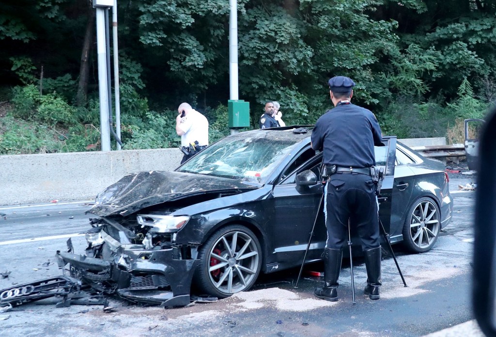 A severely damaged car at the scene of the fatal accident.