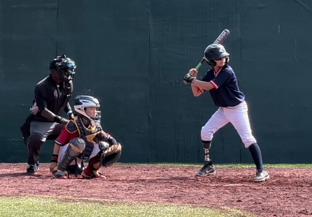Jameson Reeder Jr. at bat with catcher and umpire.