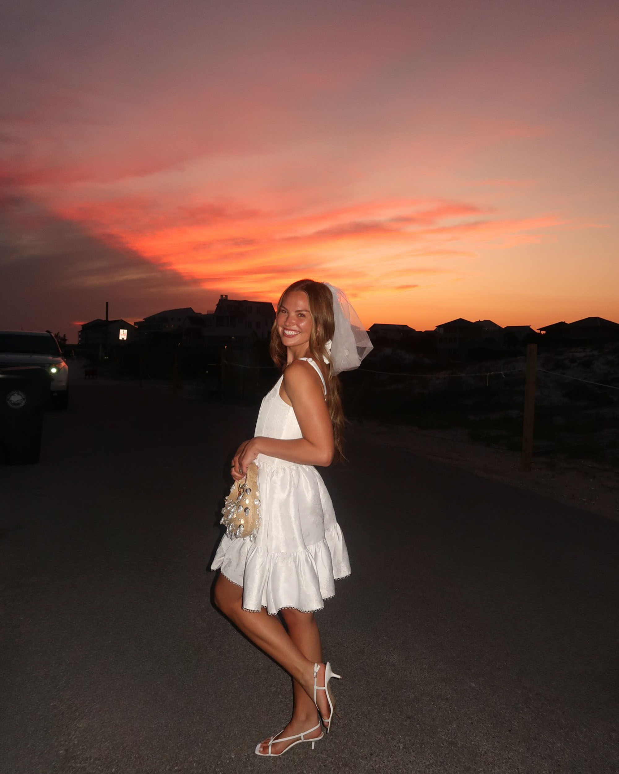 Hannah Brown in a white dress and short veil. 