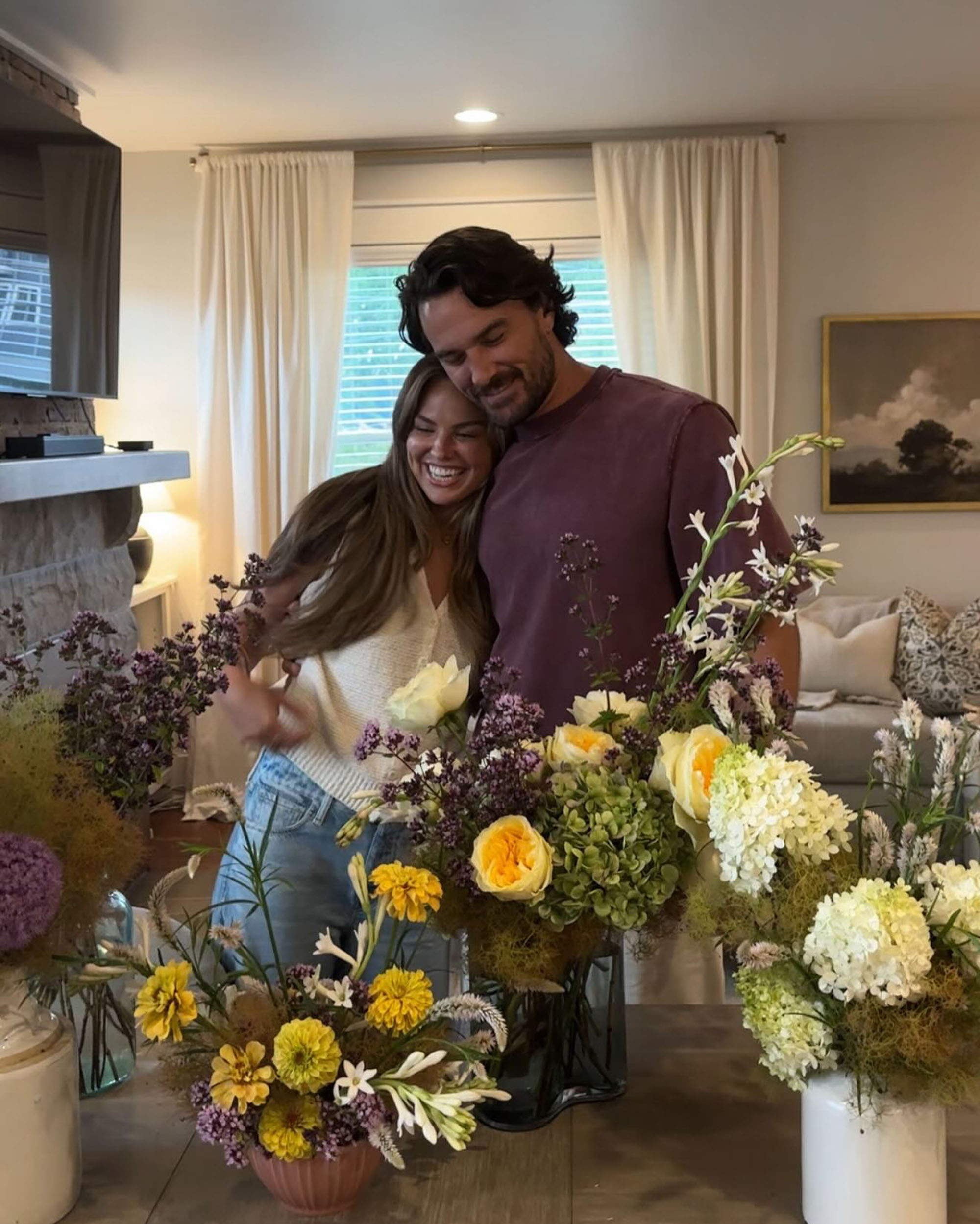 Hannah Brown with Adam Woolard looking at flowers. 