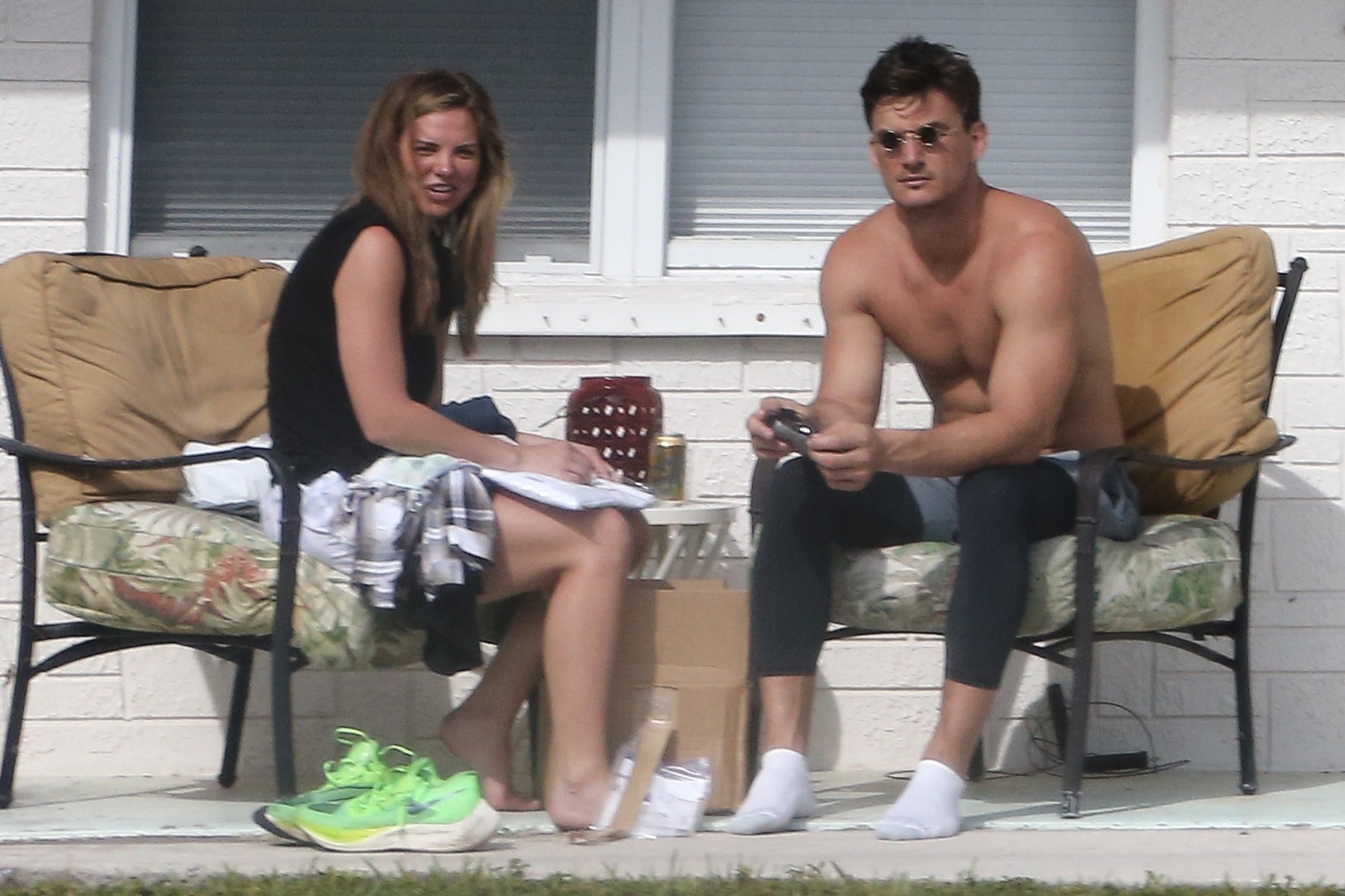 Hannah Brown and Tyler Cameron sit outdoors. 