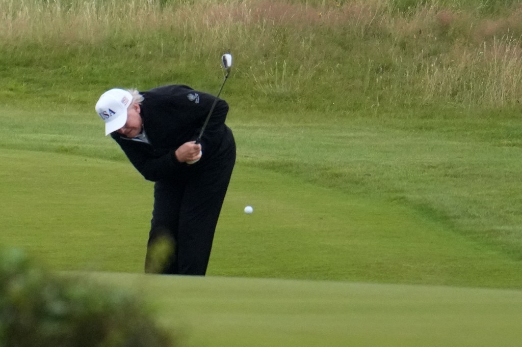 Trump taking a swing during his Sunday golf round.