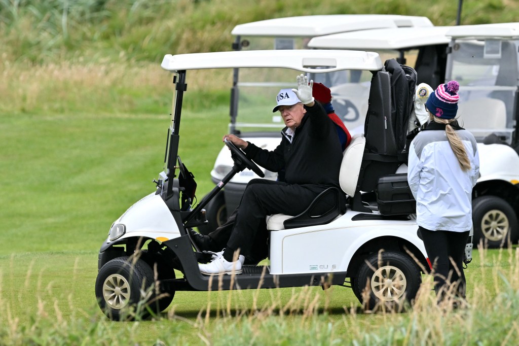 Trump waving from a traditional golf cart at Turnberry on July 27, 2025.