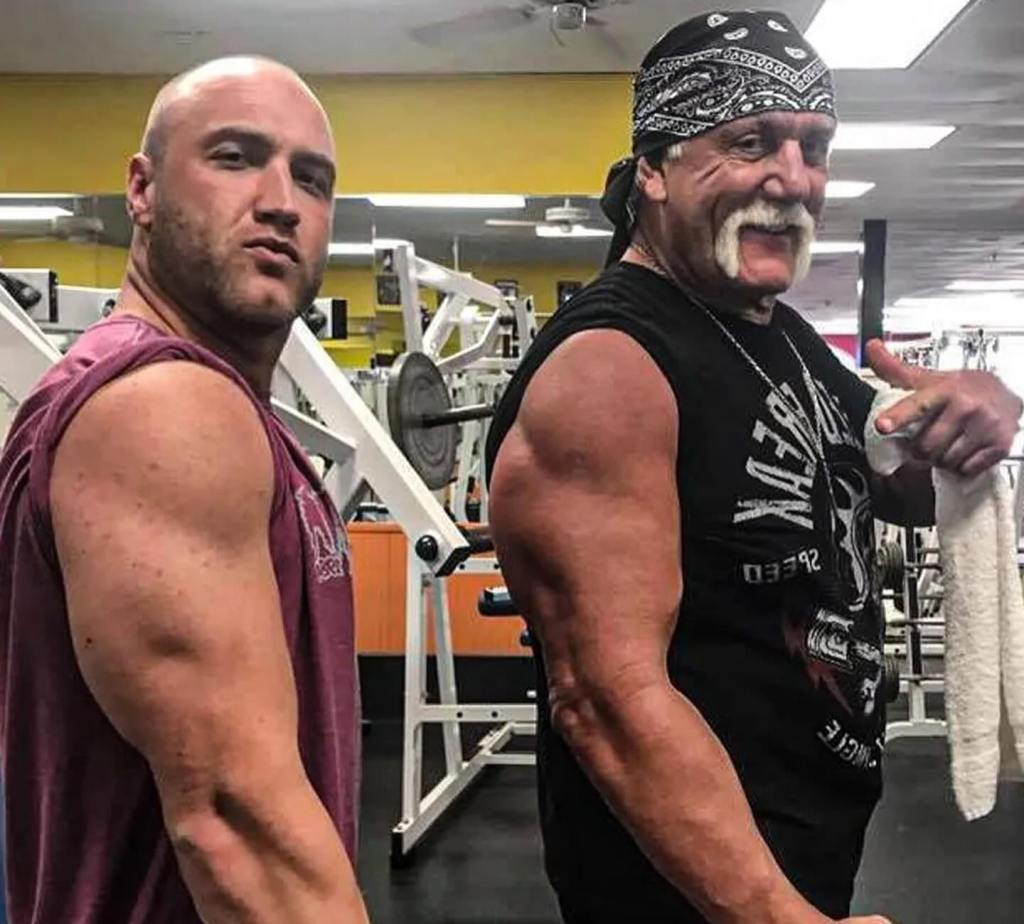 Hulk Hogan and his son, Nick Hogan, flexing their arms.