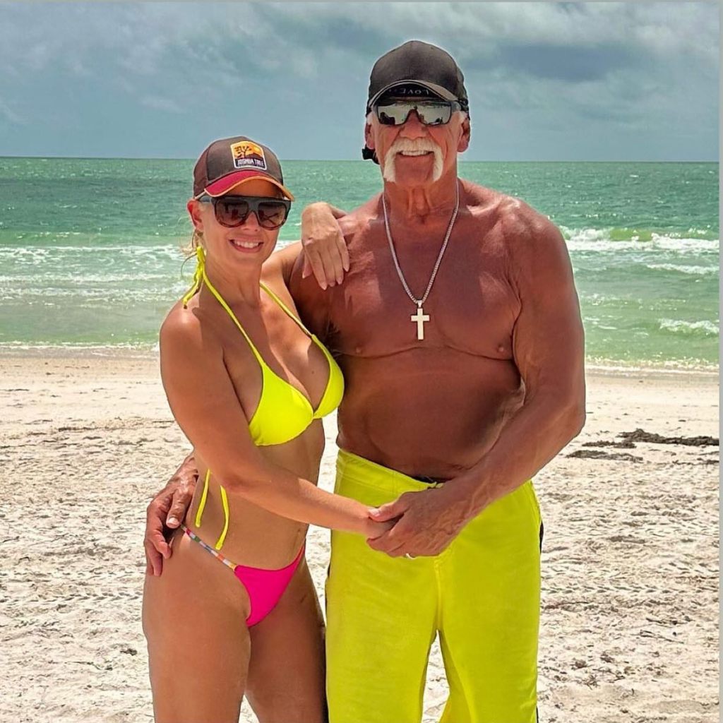 Hulk Hogan and his third wife, Sky Daily posing on the beach.
