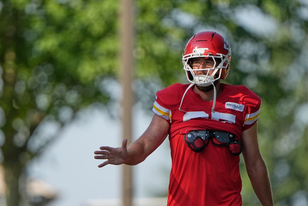 Kansas City Chiefs tight end Travis Kelce waves to fans as he walks to practice during Back Together Weekend at the team's NFL football training camp, 