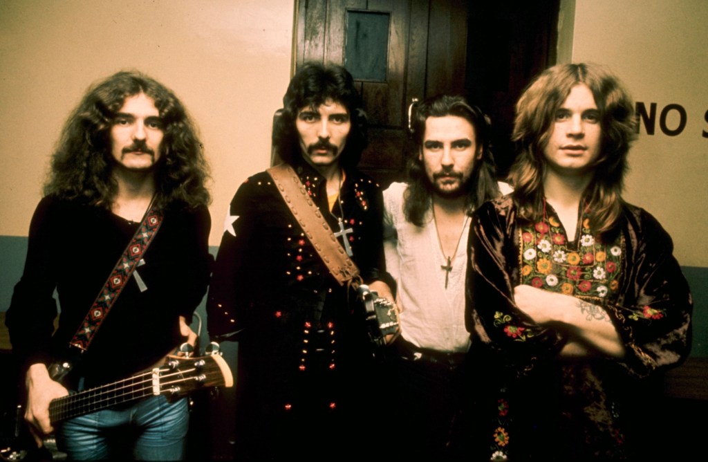 Black Sabbath members Geezer Butler, Tommy Iommi, Bill Ward and Ozzy Osbourne posing for a picture.