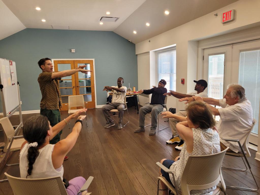 Group of people participating in a seated exercise class.