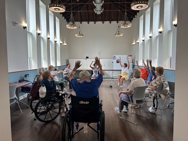 Movement and music program participants exercising.