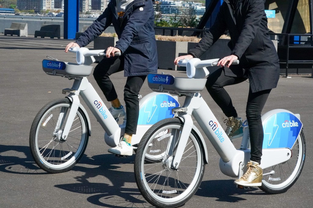 Two people riding Citi Bikes.