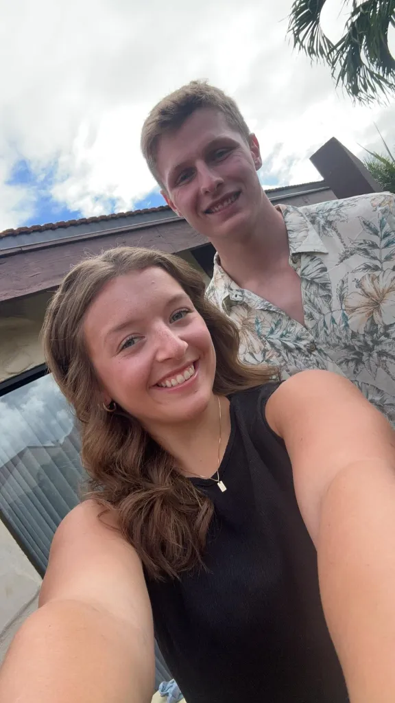 Selfie of a young man and woman smiling.