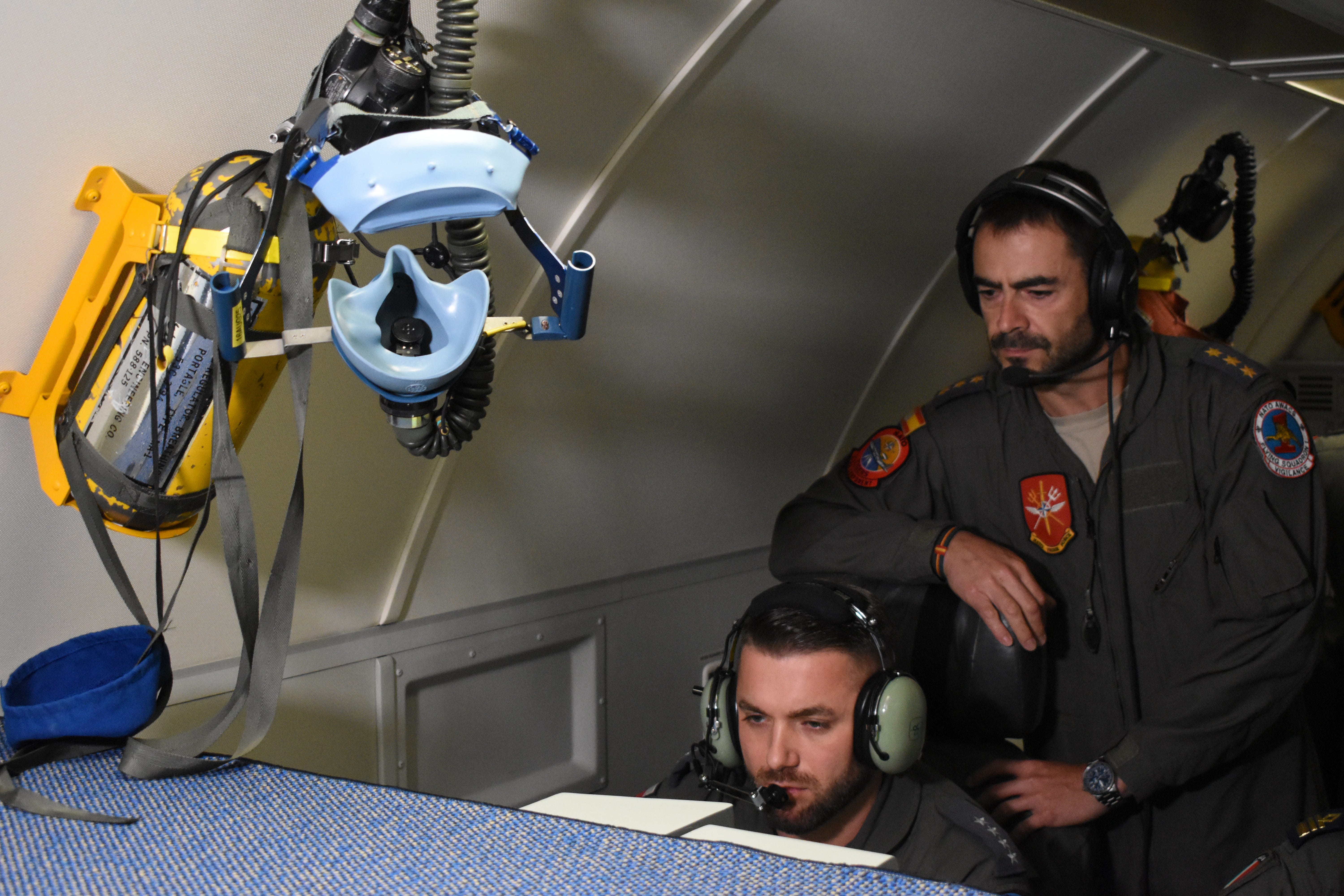 Two crew member monitor a screen on a NATO E-3 Sentry aircraft in July 2025.