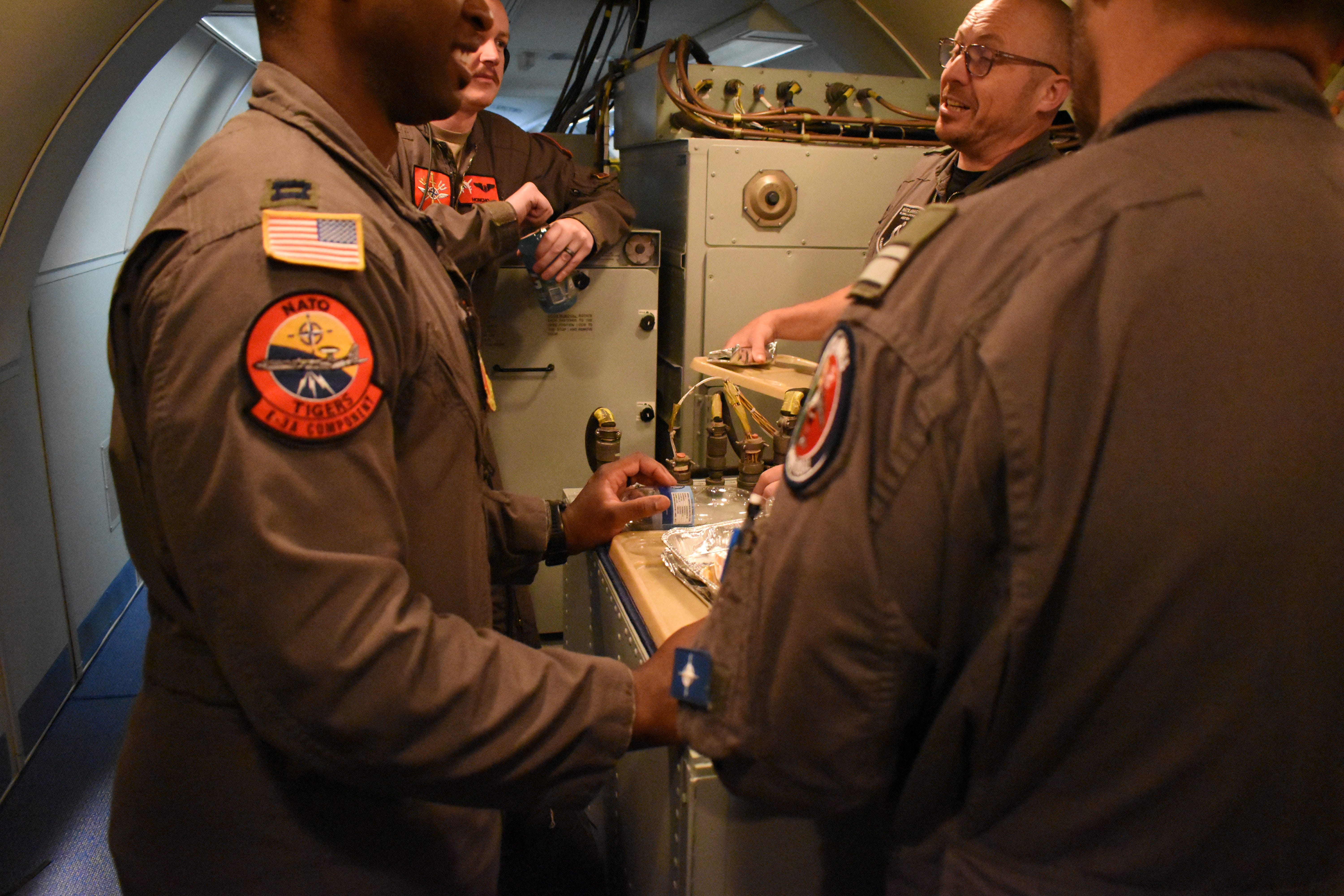 Crew members have a conversation on a NATO E-3 Sentry aircraft in July 2025.