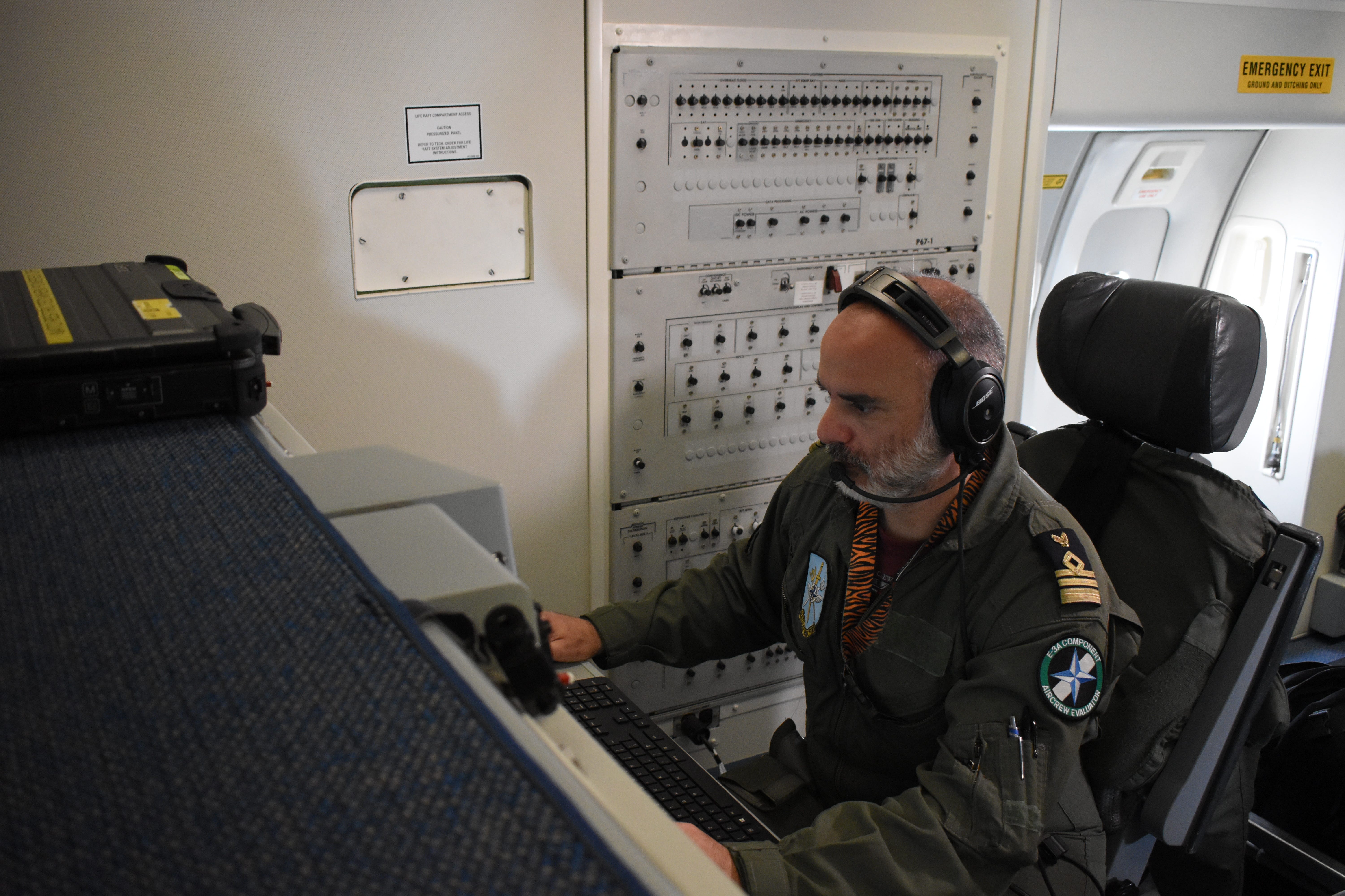 A crew member works at a screen inside a NATO E-3 Sentry aircraft in July 2025.
