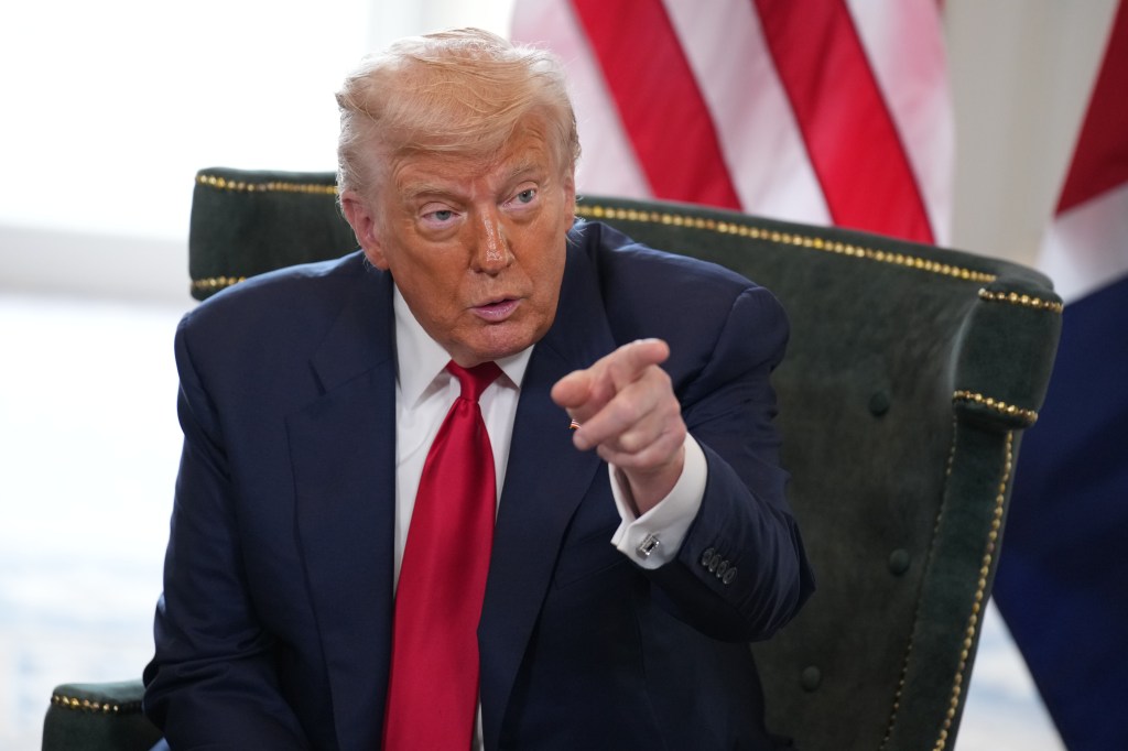 President Donald Trump pointing during a meeting.