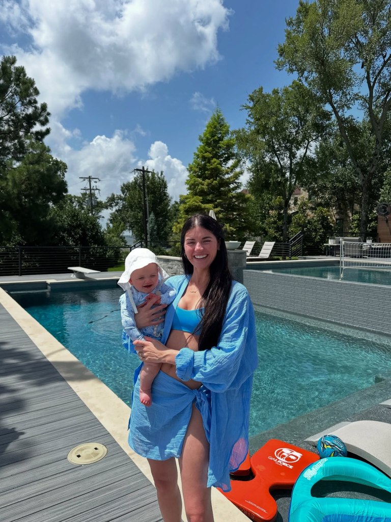 Madi Prewett carrying her daughter, Hosanna.
