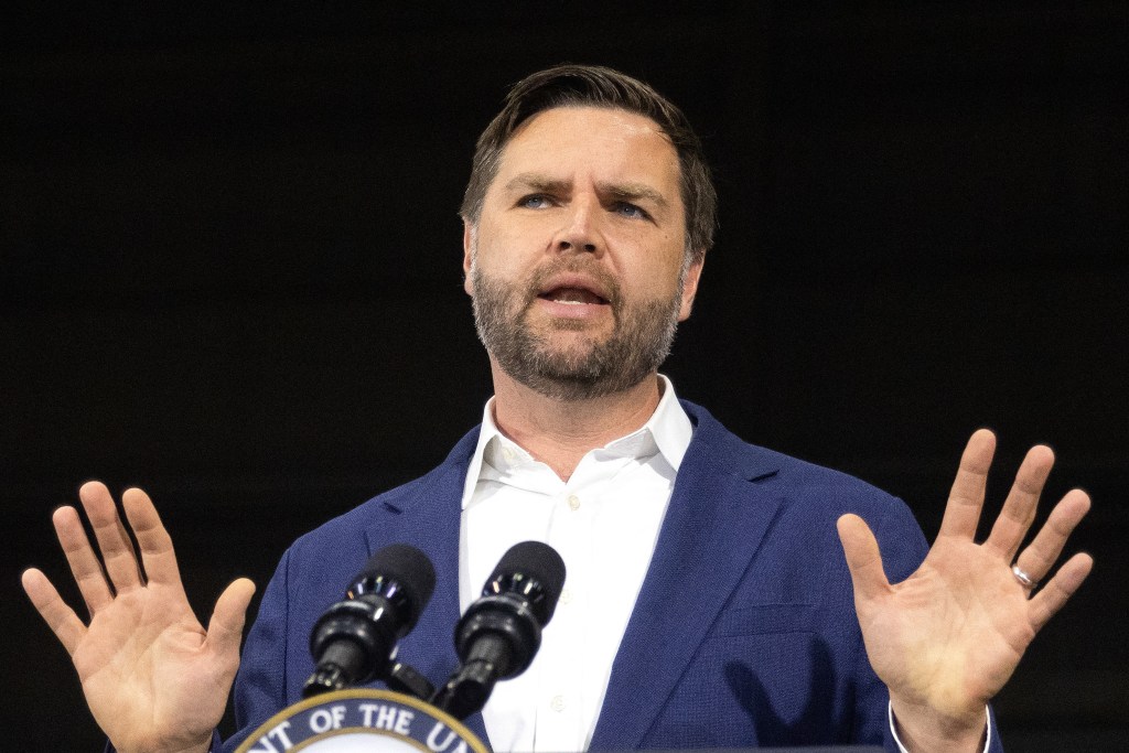 JD Vance speaking at a podium.