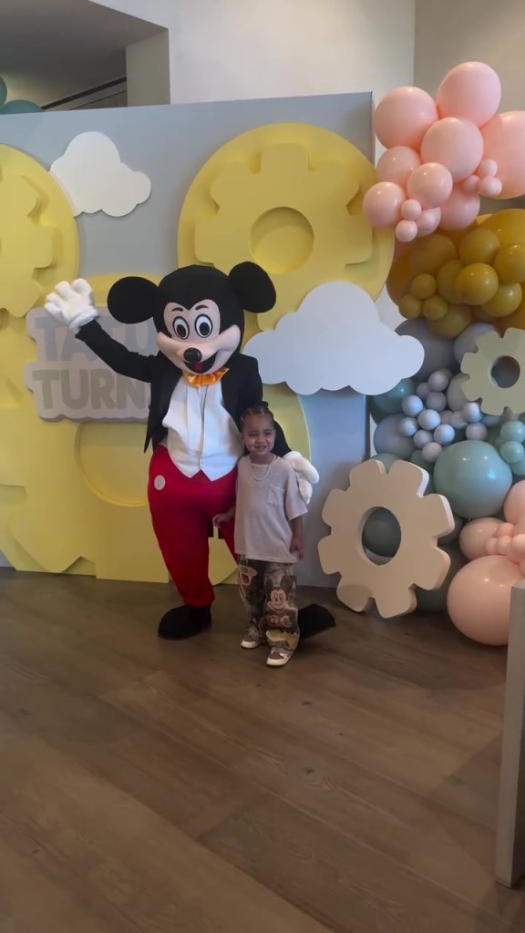 Tatum Thompson posing with Mickey Mouse.