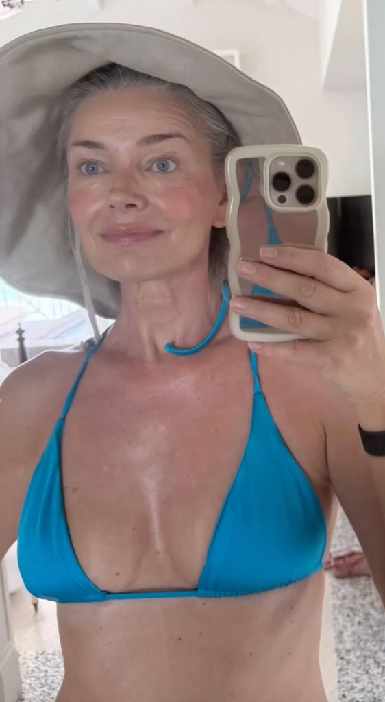 Paulina Porizkova in a bikini taking a selfie.