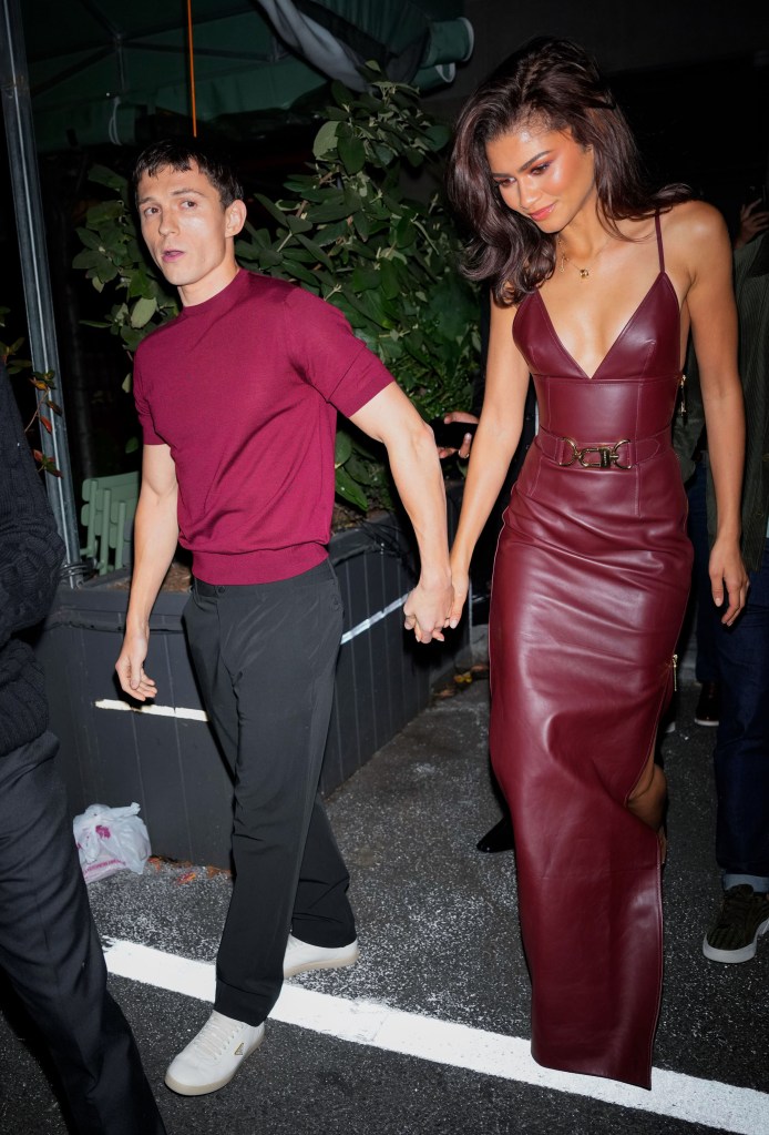 Tom Holland and Zendaya holding hands.