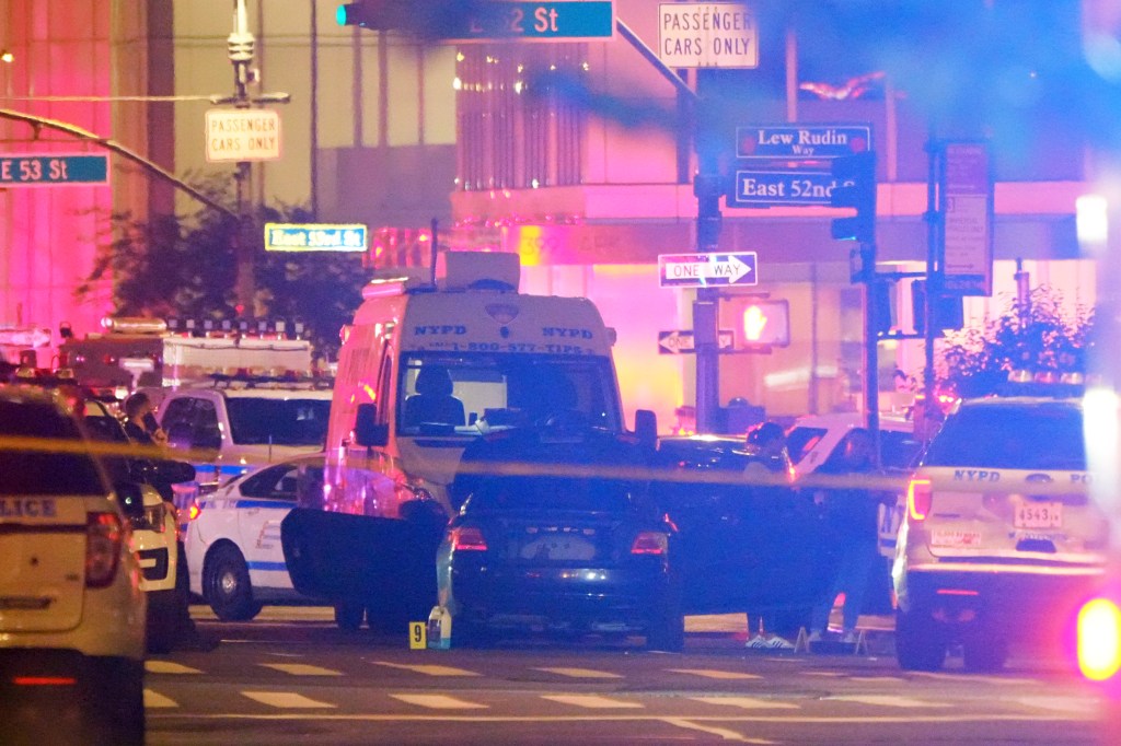Evidence markers next to a car near scene of mass shooting near 345 Park Avenue
