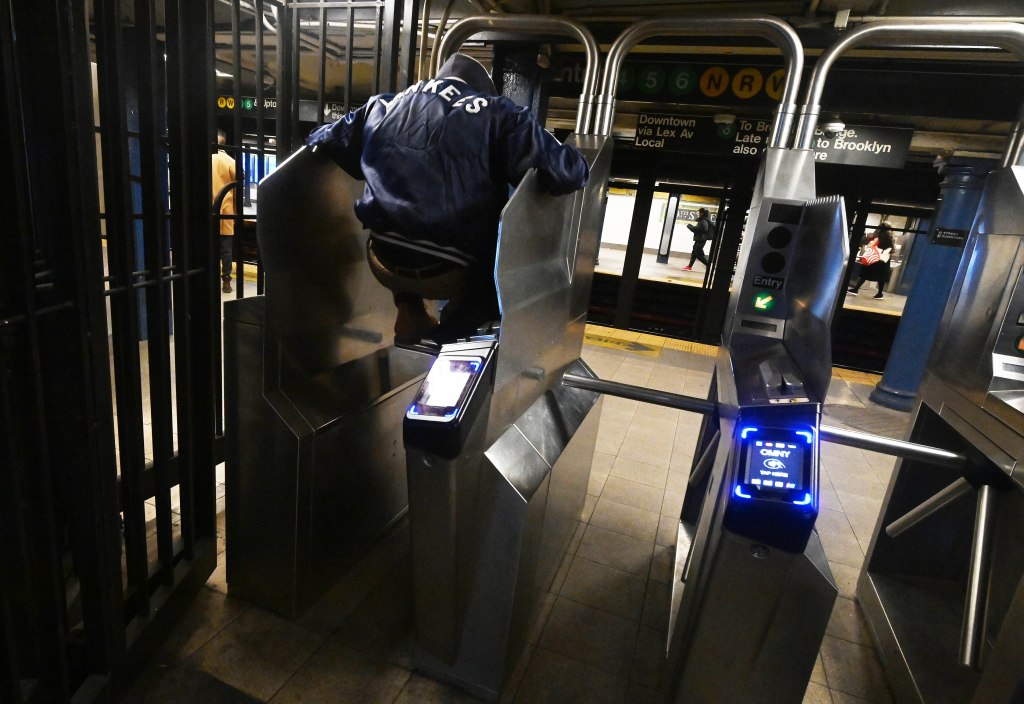 Person jumping over a subway turnstile.
