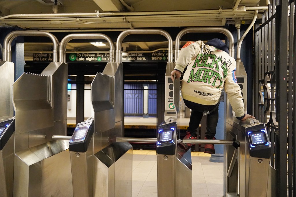 Person jumping over a subway turnstile.