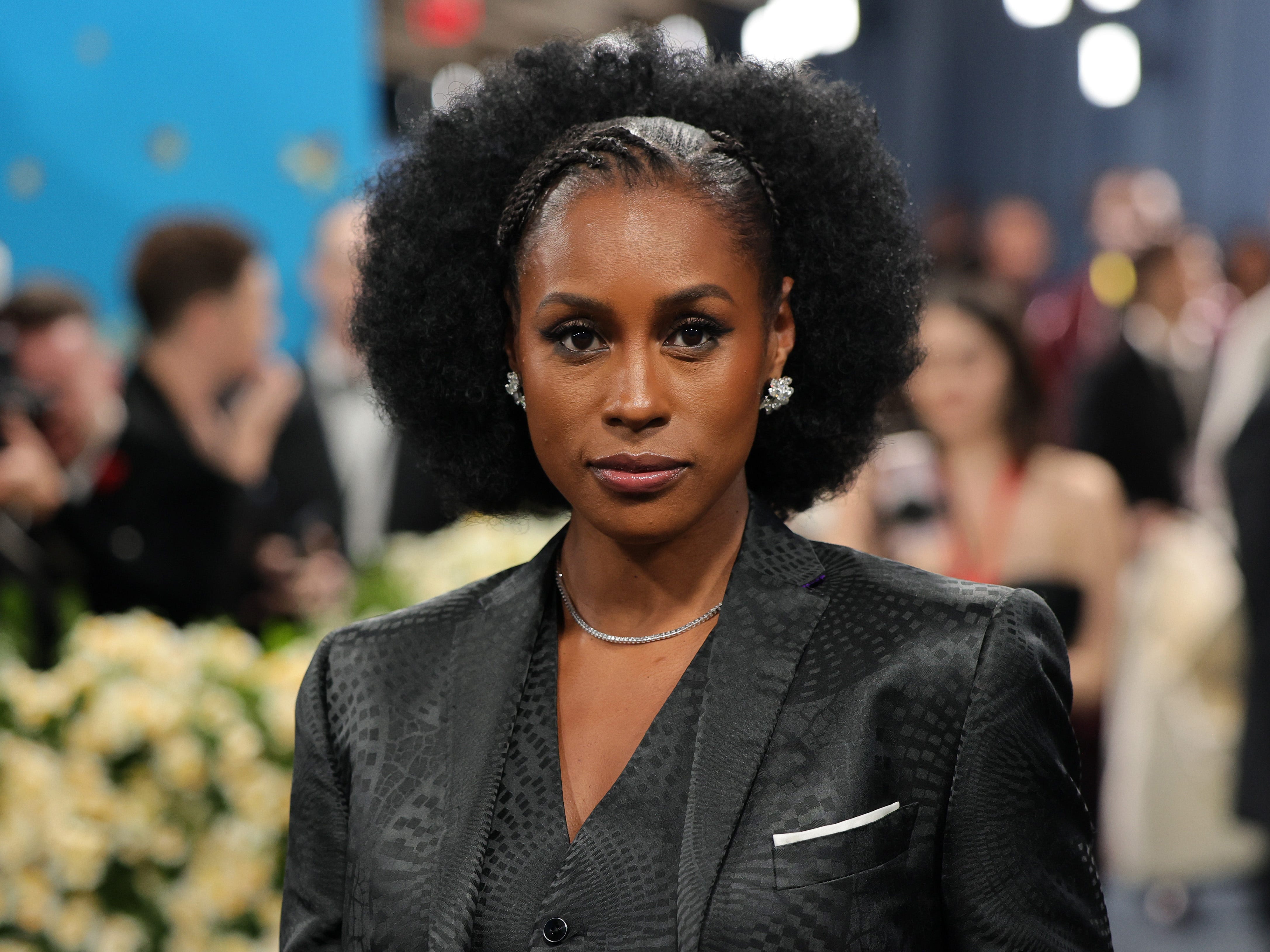 Issa Rae posing on the carpet of the 2025 Met Gala Celebrating "Superfine: Tailoring Black Style."