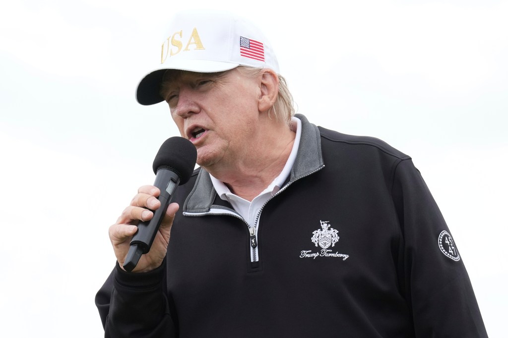 Donald Trump speaking into a microphone.